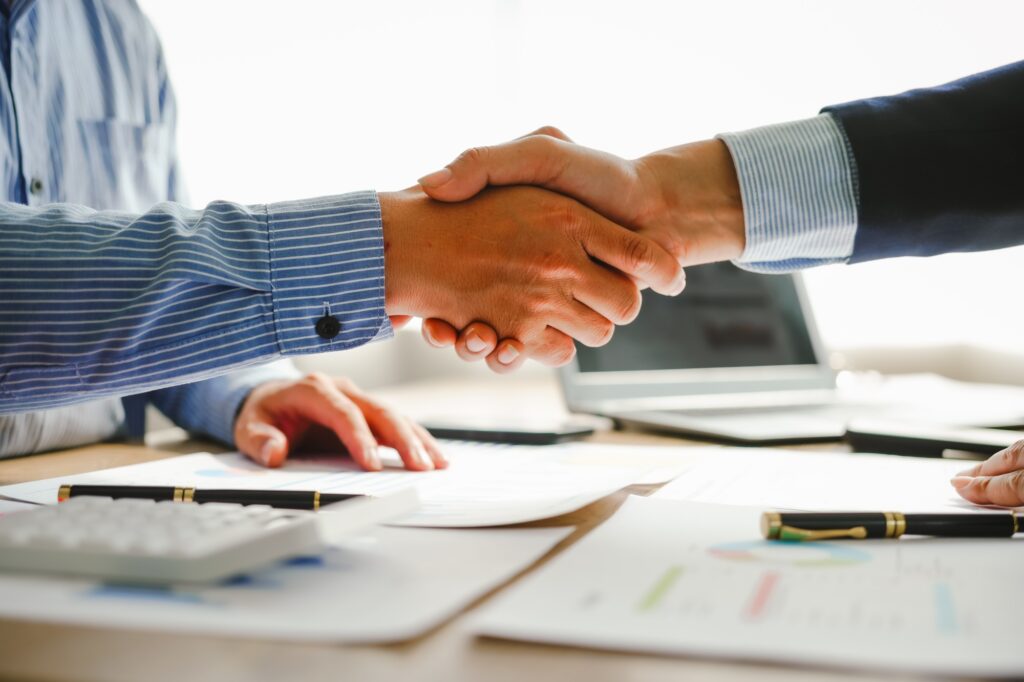 Businessman conducts financial discussions, sealing deals with handshakes. Expert in accounts, loans