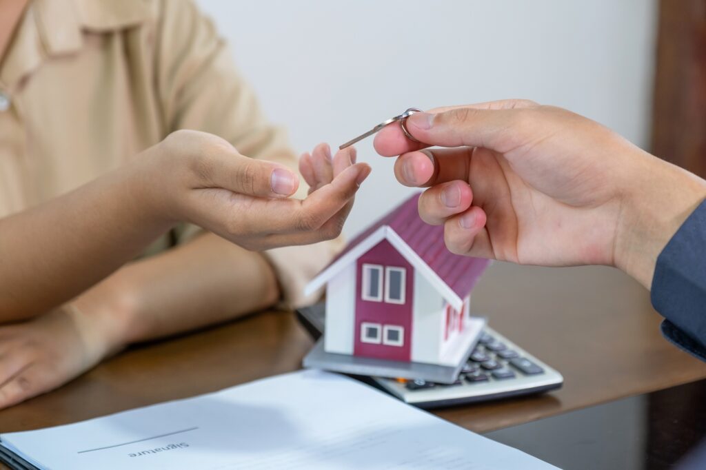 Real estate agents and buyers discuss signing a business contract, mortgage, loan or home insurance